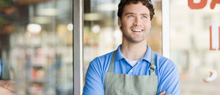 Small Business owner in front of his business